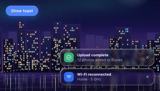 Two stacked notification cards at the lower right, with a solid trigger button at the top left, over a zoomed night skyline and its waterline.
